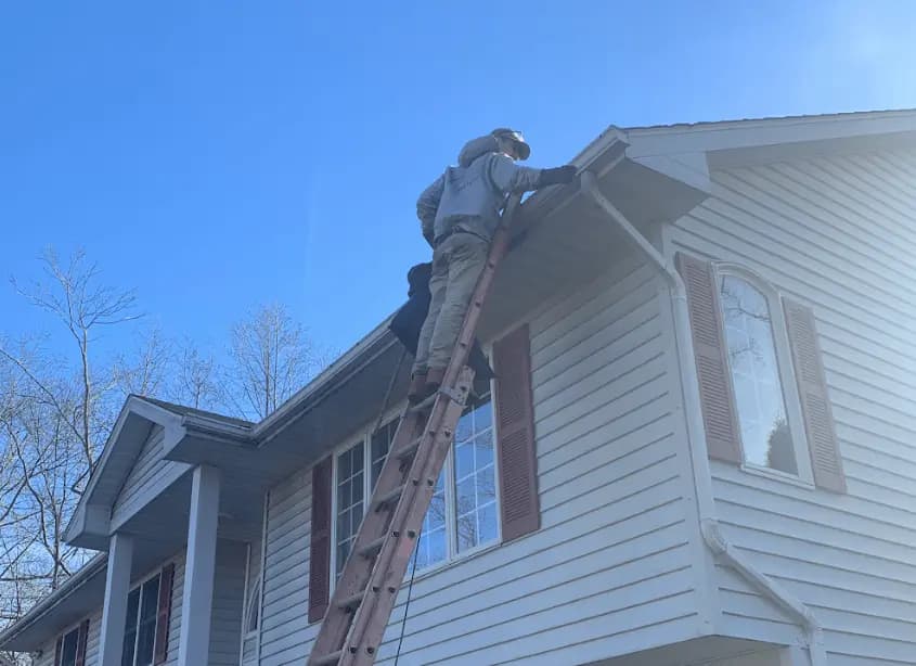 Gutter cleaning and maintenance being performed by Aurora Power Washing in Aurora