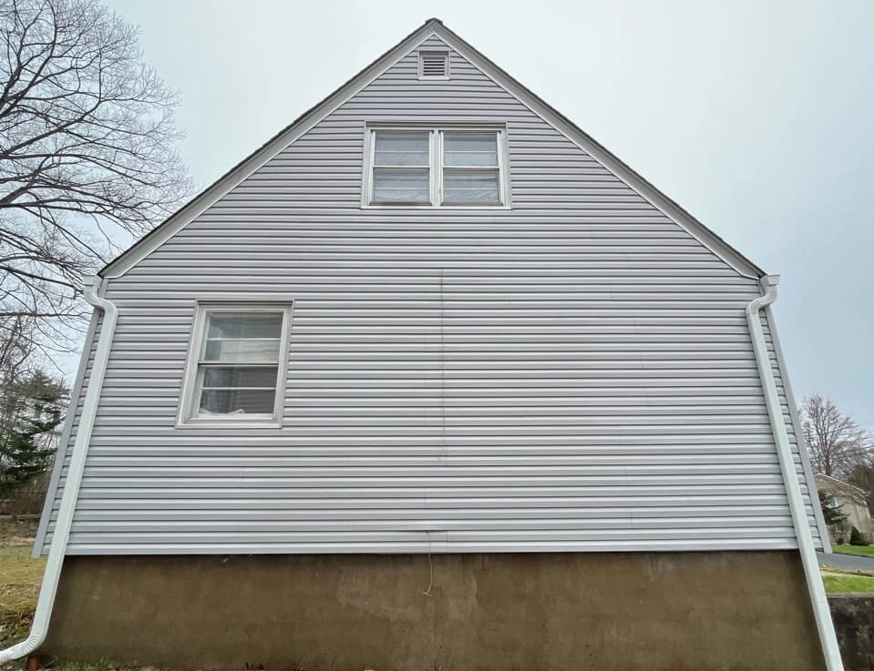 Aurora Power Washing technician performing detailed house washing in Aurora residential area